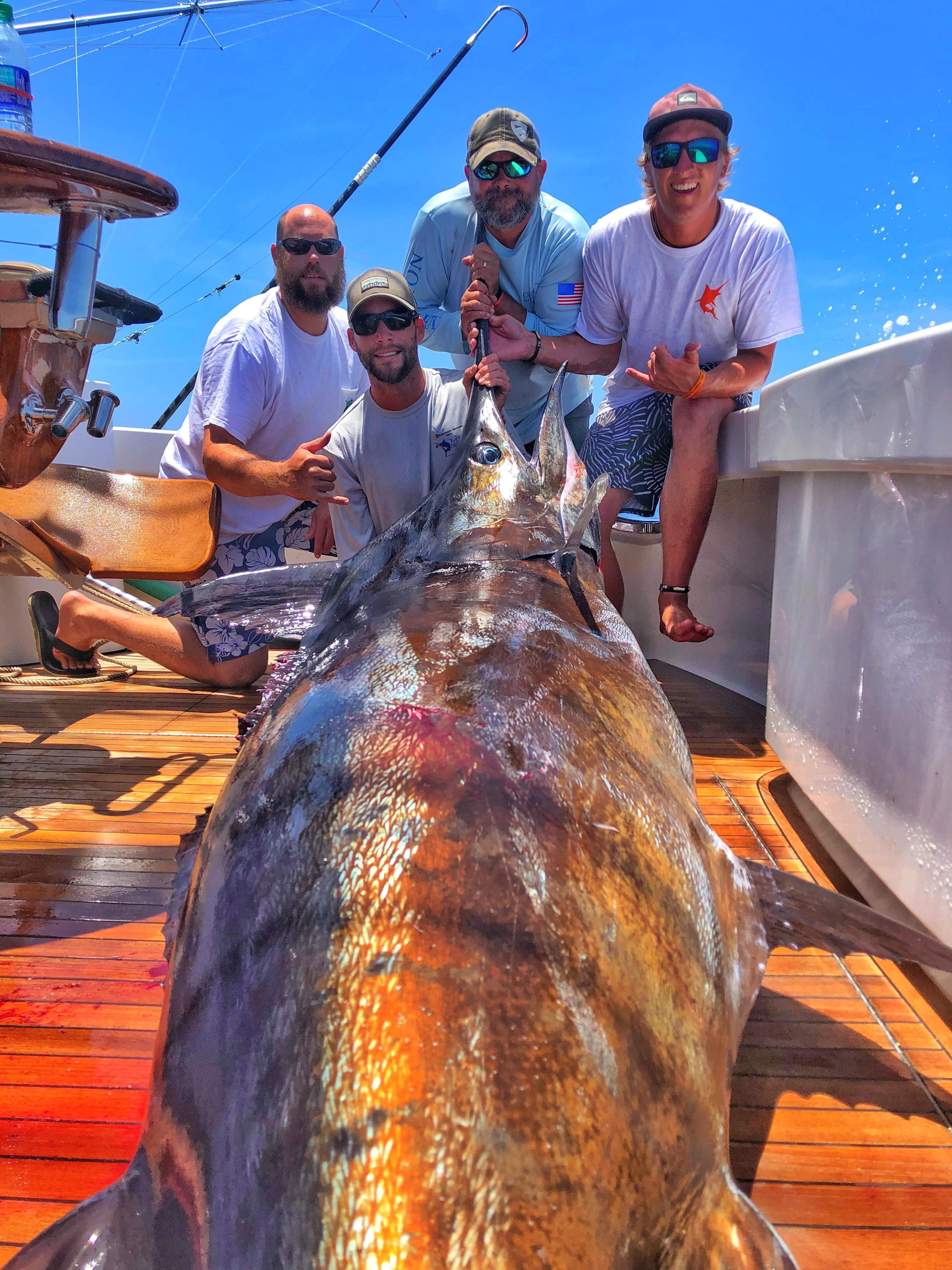 The crew aboard the Wynsong hauled in this 699.3-pound blue marlin during the Cajun Canyons Billfish Classic last weekend in Louisiana. The marlin, caught by Zach Tokheim, measured 119 inches and took four-hours to haul in. Pictured from left are Capt. Allen Staples, Capt. Caleb Brown, Chris Sheppard and Zach Tokheim. [CONTRIBUTED PHOTO]