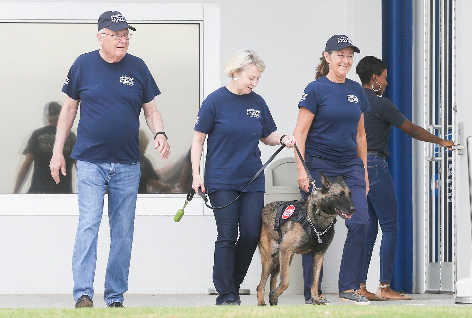 American Humane staff bring retired military dog Luna out during a reunion with former handler Staff Sgt. Porschia Allio-Easom, at the Eglin Federal Credit Union on Eglin Parkway in Fort Walton Beach.